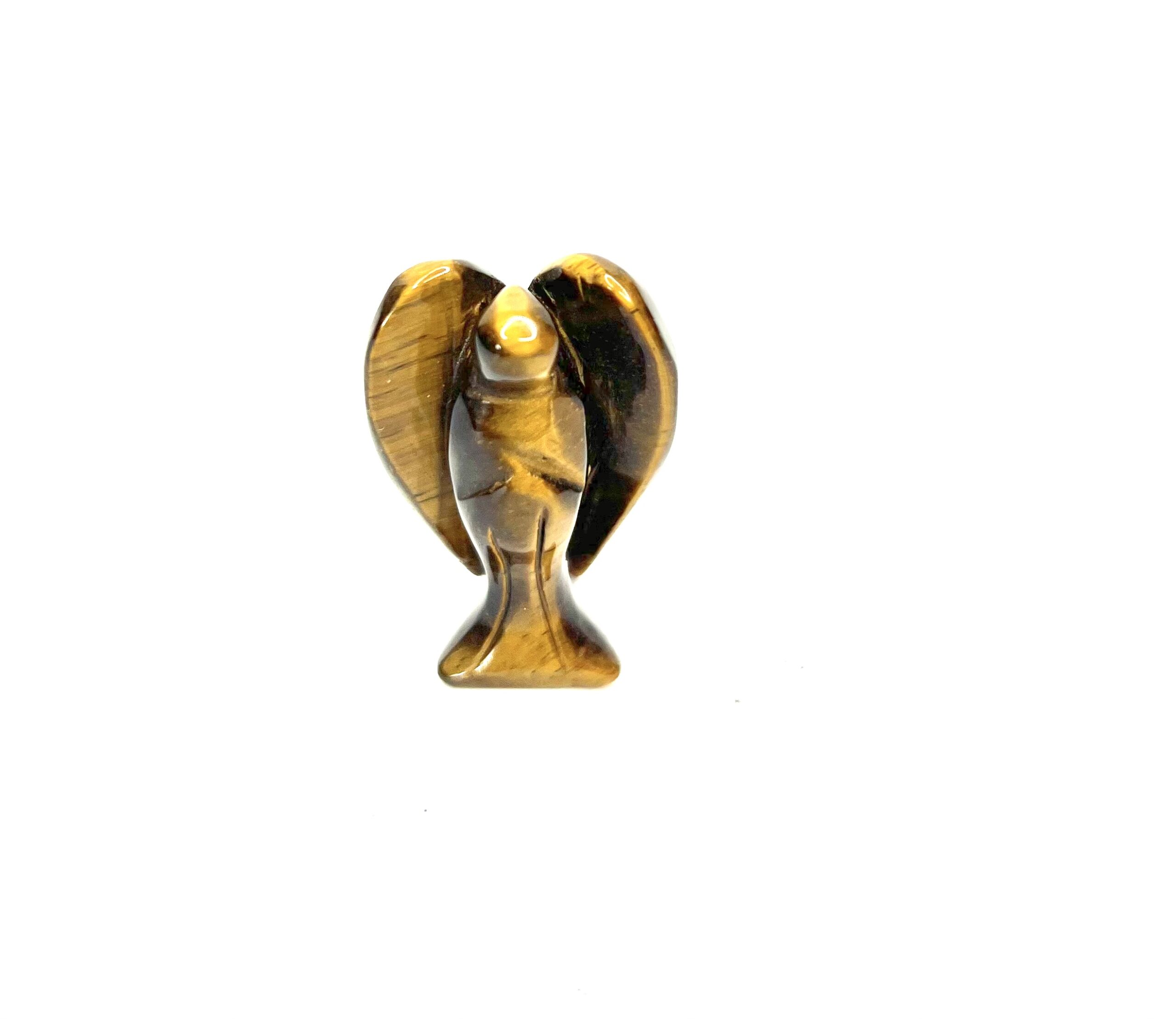 A gold bird statue sitting on top of a white table.