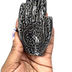 A hand with a flower carved on it