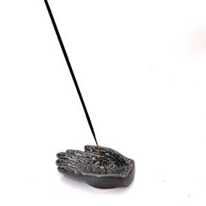 A black stone with a stick in it