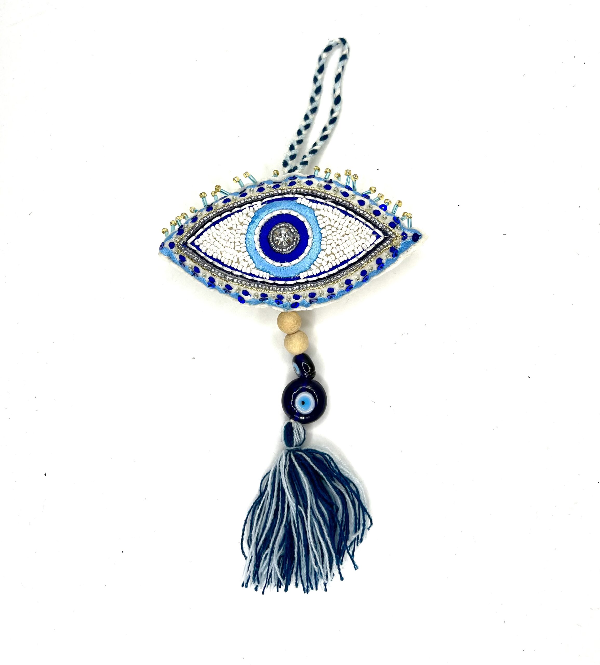 A blue and white evil eye hanging from a gray tassel.