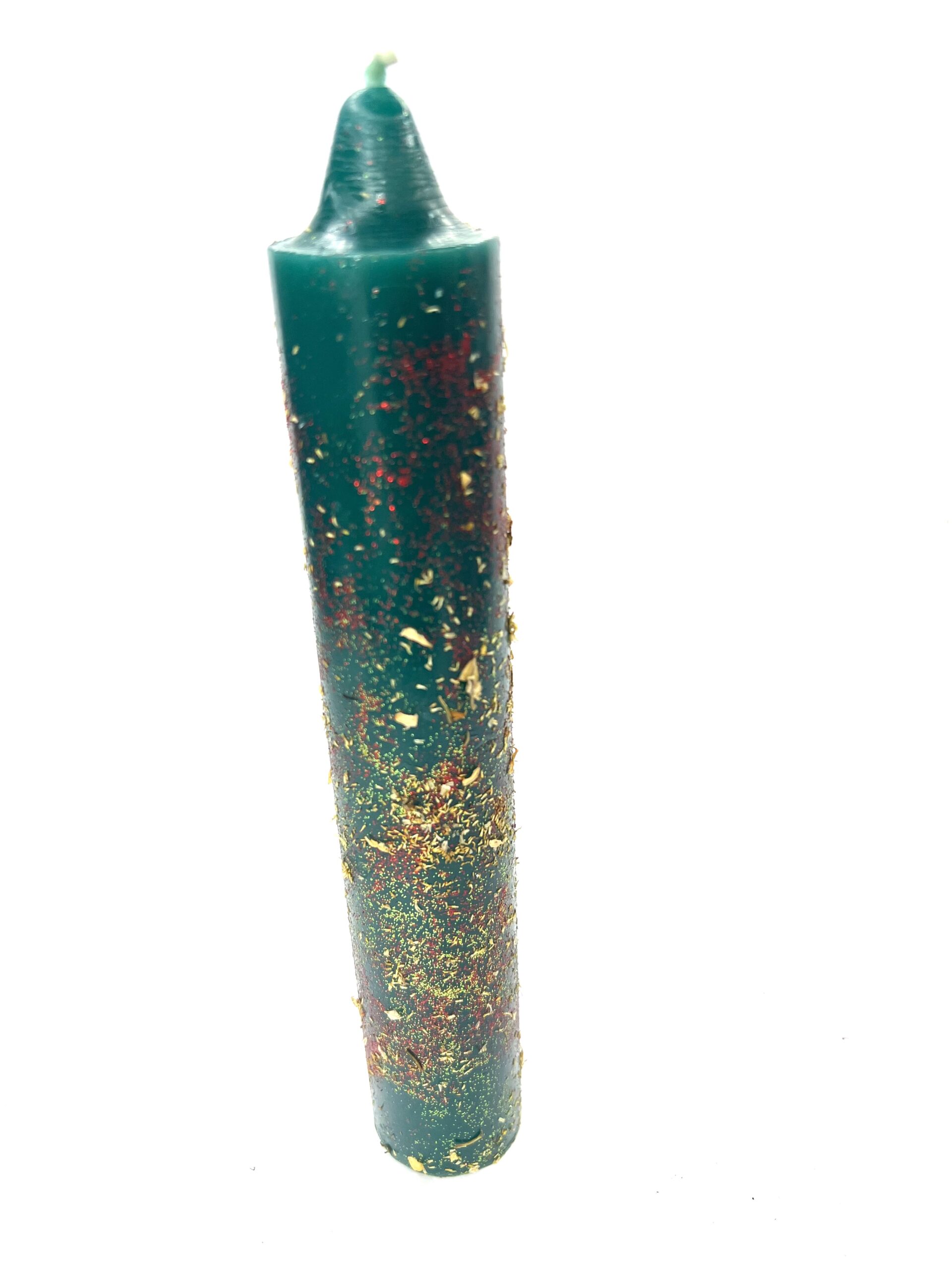 A green candle with gold and red flakes on it.