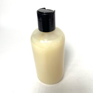 A bottle of lotion sitting on top of a table.