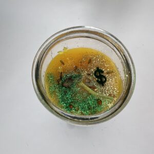 A jar of liquid with some green stuff in it