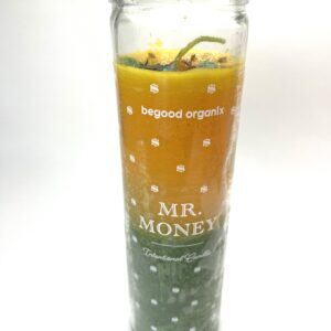 A glass with an orange and green drink in it.