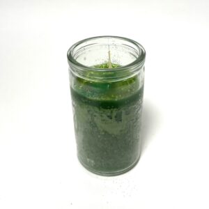 A candle that is sitting in a glass.