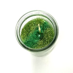 A candle is sitting in a glass jar.