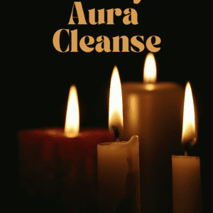 Three candles with the words aura cleanse in front of them.