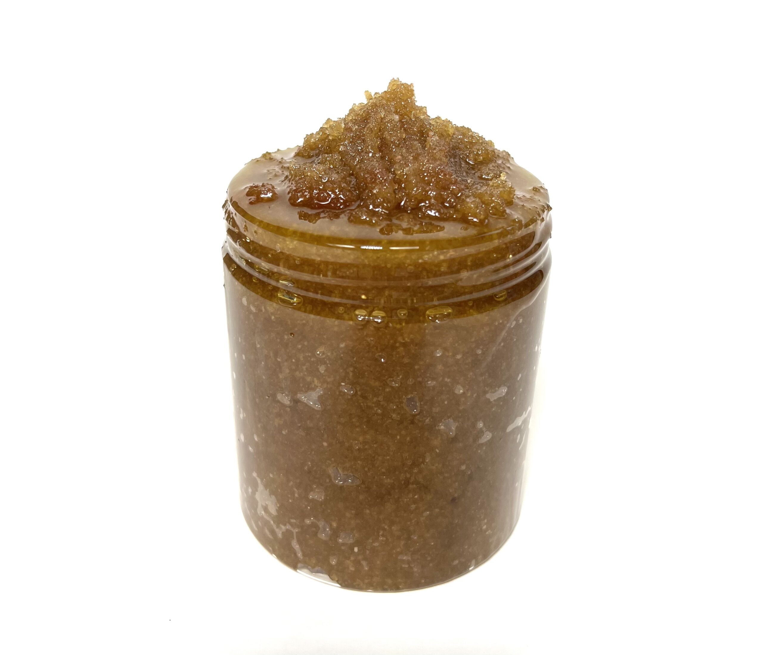 A jar of brown sugar on top of white background.