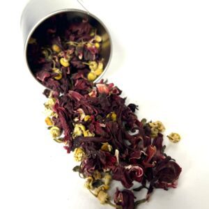 A metal cup filled with red and yellow flower petals.