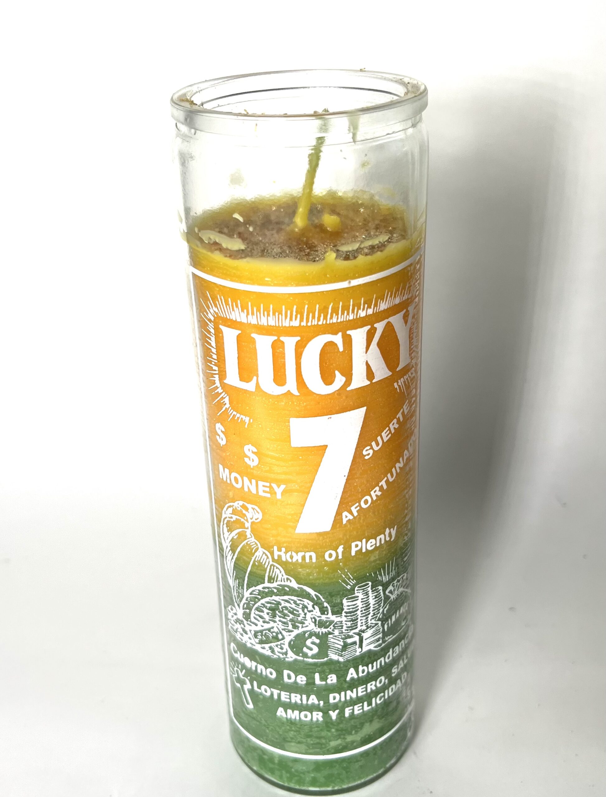 A candle that says lucky 7 on it.