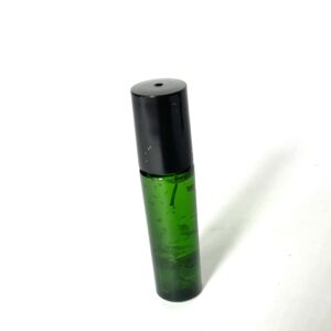 A green bottle with black cap on white surface.