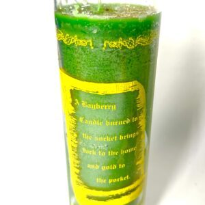 A green candle with the words " prosperity " written on it.