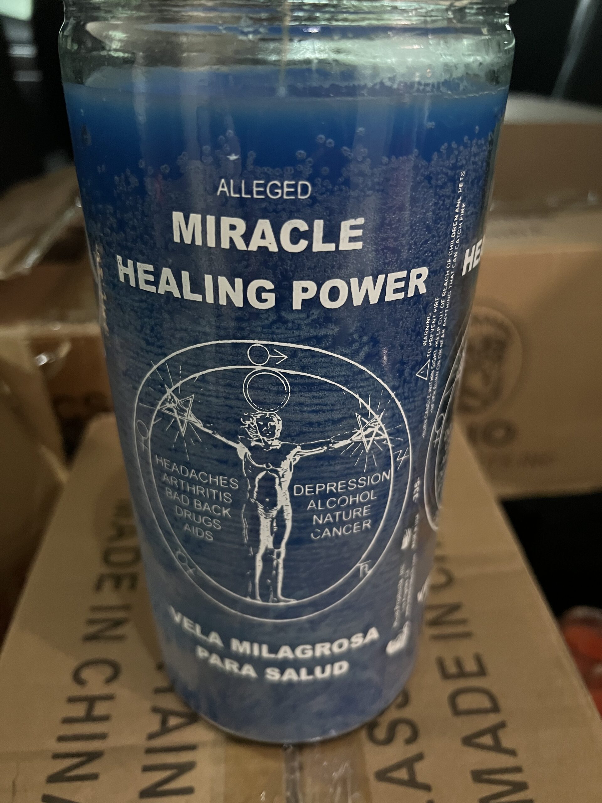 A cup of miracle healing power on top of a box.