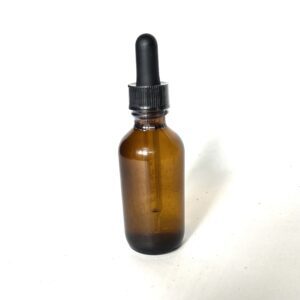 A brown bottle with black cap on white background