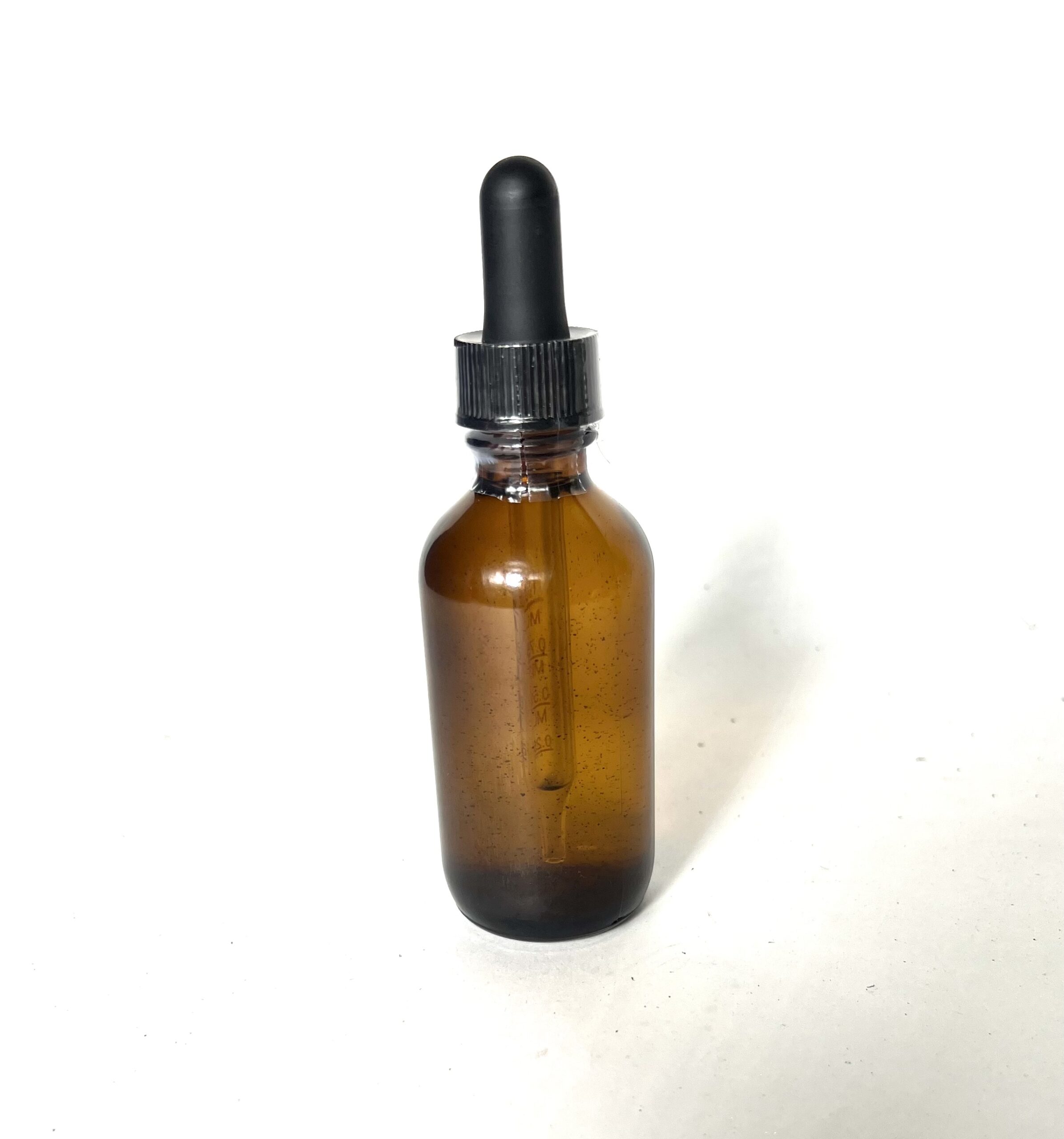 A brown bottle with black cap on white background