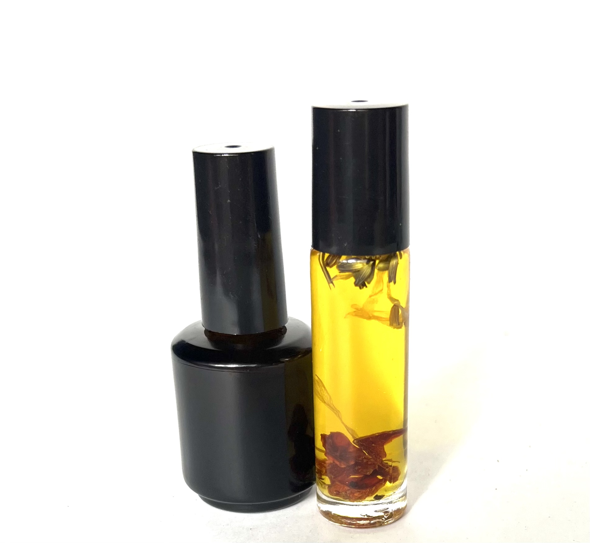 A bottle of oil and a container with some flowers.