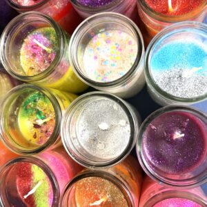 A group of candles that are in jars.