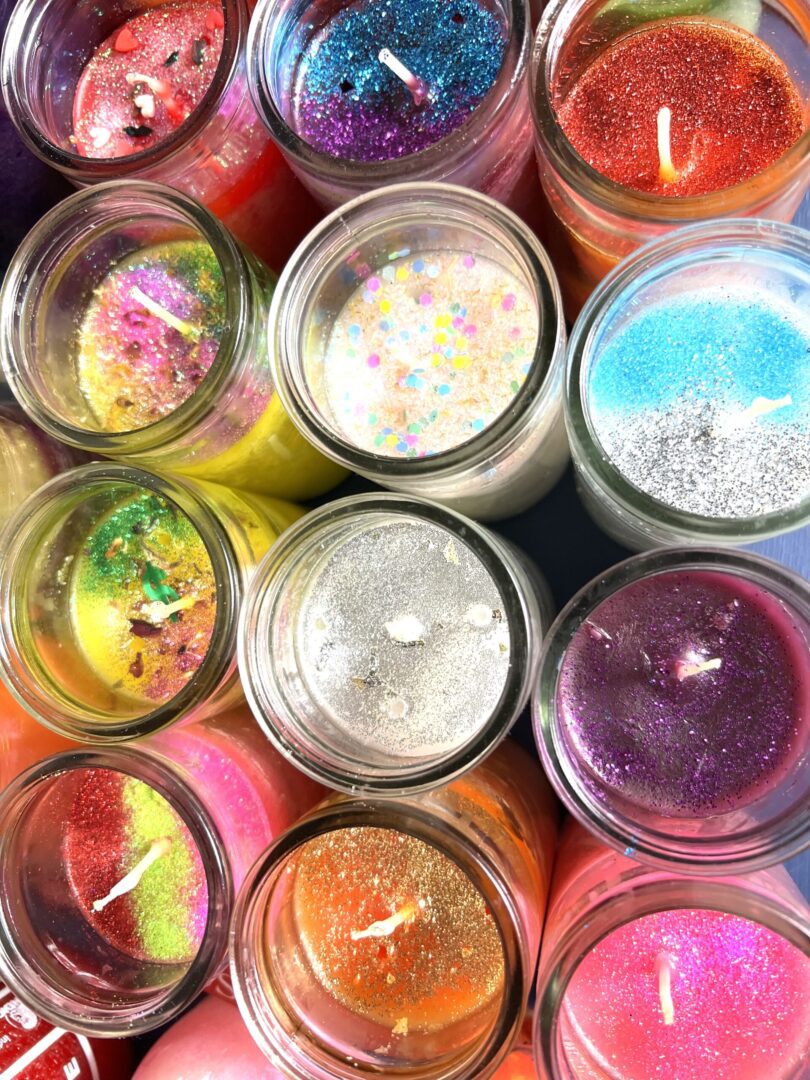 A group of candles that are in jars.