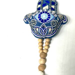 A blue and white hamsa hand with wooden beads.