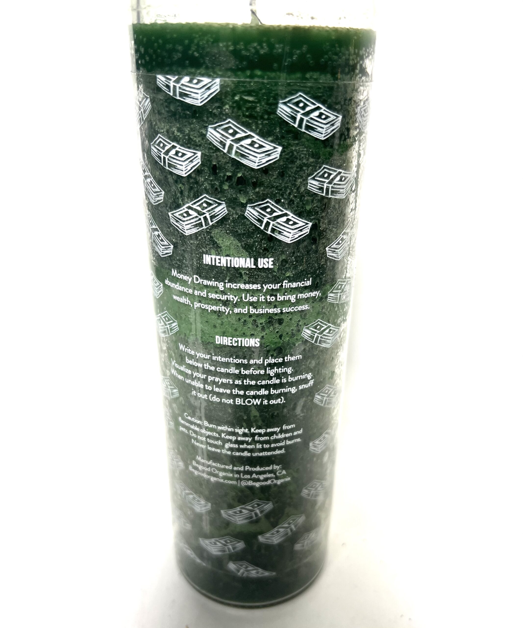 A tall glass with green lego bricks on it.