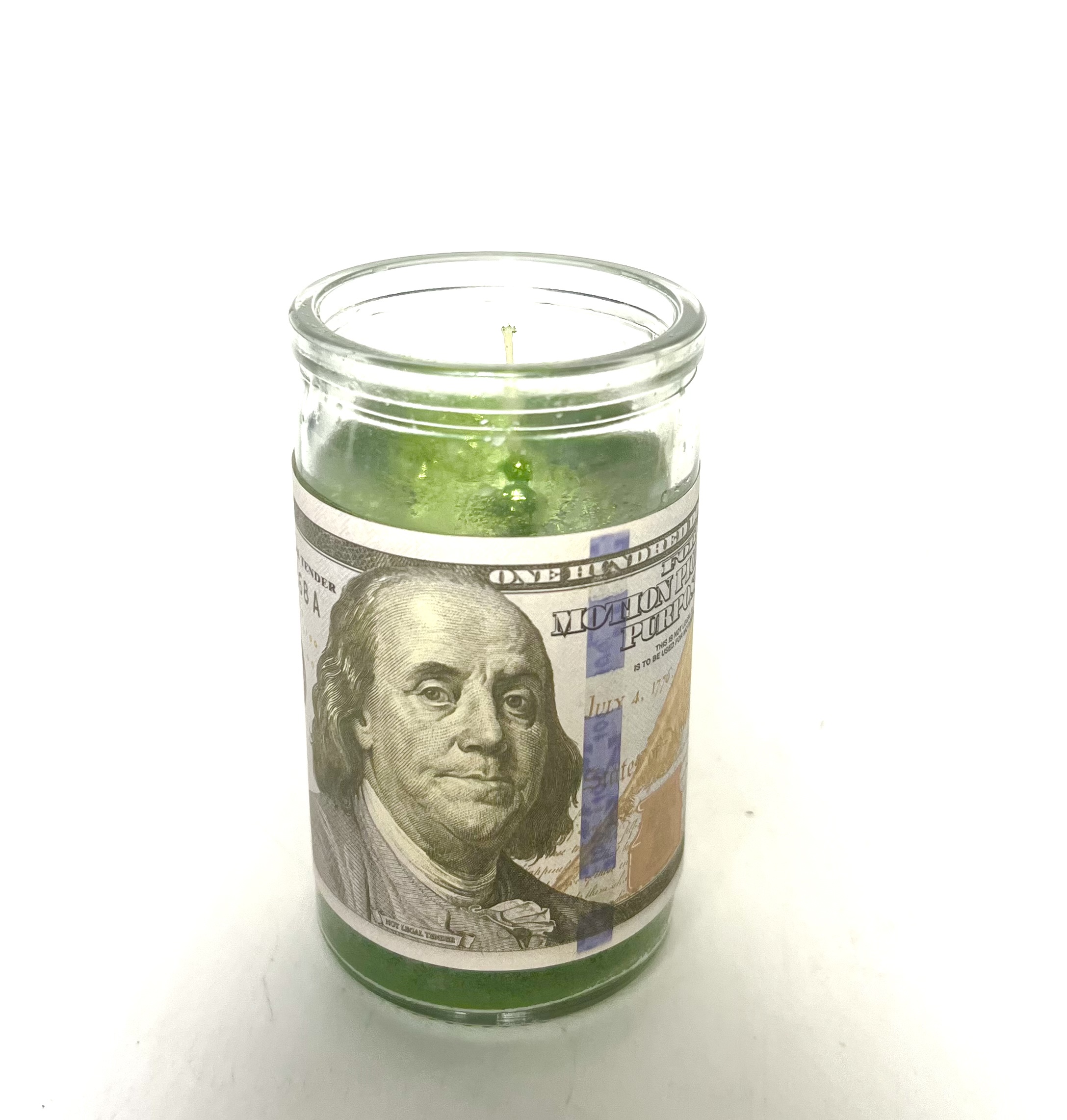 Green candle with Benjamin Franklin on it.