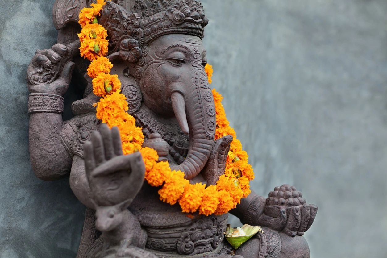 Ganesha statue with flower garland.