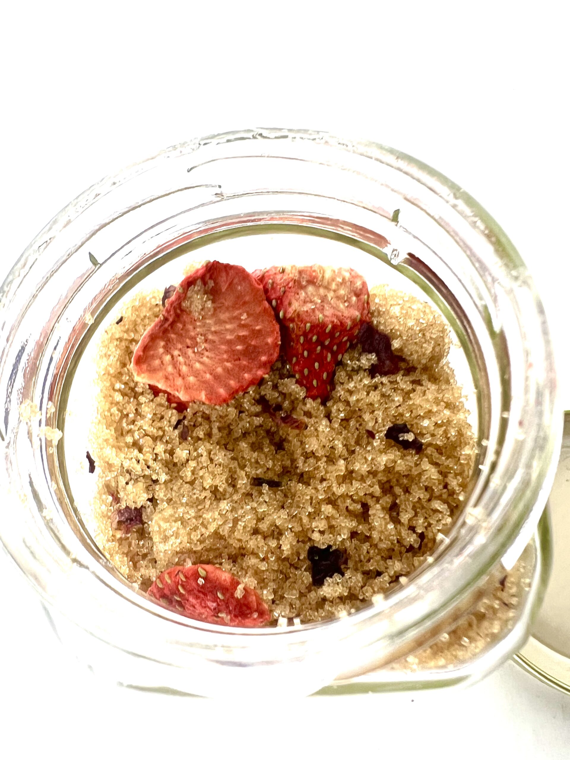 Dried strawberries in brown sugar jar.