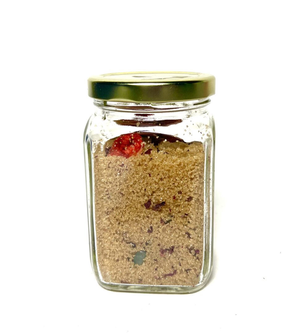 Glass jar filled with brown sugar and fruit.