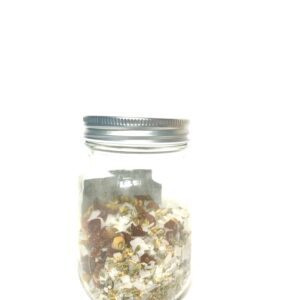 A glass jar filled with popcorn against a white background.