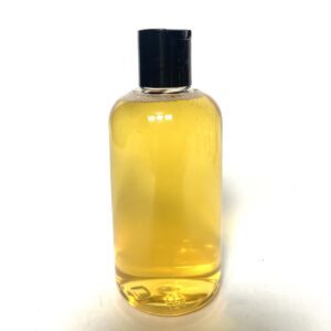 A clear bottle filled with yellow liquid and a black cap.