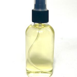 A clear spray bottle filled with light yellow liquid.