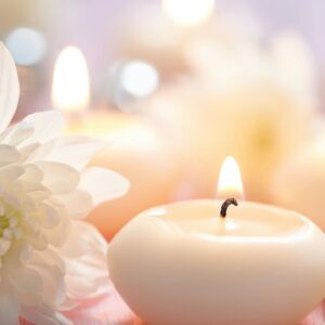 Softly glowing candles with delicate flowers create a peaceful ambiance.