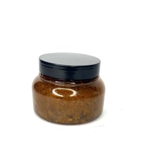 A small glass jar filled with brown paste and a black lid.